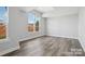 Bedroom featuring luxury vinyl plank flooring and a large window offering natural light and neighborhood views at 143 Carriage Club Dr # 102, Mooresville, NC 28117
