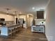 Open kitchen featuring a large island, stainless steel appliances, and adjacent staircase at 143 Carriage Club Dr # 102, Mooresville, NC 28117