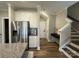 Bright kitchen flowing to staircase showcasing stainless steel appliances and modern finishes at 143 Carriage Club Dr # 102, Mooresville, NC 28117