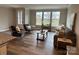 Spacious living room with large windows offering ample natural light and backyard views at 143 Carriage Club Dr # 102, Mooresville, NC 28117