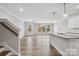 View of the open-concept living room with backyard access, and adjacent kitchen with granite countertops at 143 Carriage Club Dr # 102, Mooresville, NC 28117