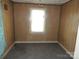 Bedroom featuring wood paneling, carpeted floors, and a window at 146 Loomis St, Chester, SC 29706