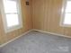 Bedroom with wood paneled walls and two windows allowing for natural light at 146 Loomis St, Chester, SC 29706