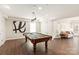 Basement game room offers a pool table, dark wood floors, recessed lighting, and a cozy seating area at 1506 Venetian Way Dr, Waxhaw, NC 28173