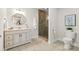 Bathroom with a stylish vanity, decorative mirror, and tiled walk-in shower at 1506 Venetian Way Dr, Waxhaw, NC 28173
