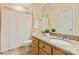 Neutral colored bathroom featuring a granite countertop, wood cabinets, and shower with a white shower curtain at 1506 Venetian Way Dr, Waxhaw, NC 28173