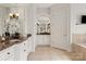 Bathroom with dual vanity sinks, granite counters, custom cabinets, and tile floors at 1506 Venetian Way Dr, Waxhaw, NC 28173