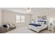 Well-lit bedroom features a cozy sitting area, crown molding, a ceiling fan, and a large window at 1506 Venetian Way Dr, Waxhaw, NC 28173