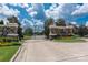 Stone and wrought iron entry gate with mature landscaping welcomes you to the community at 1506 Venetian Way Dr, Waxhaw, NC 28173