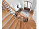 Striking entryway features wood staircase, black iron banister, hardwood floors, and a decorative front door at 1506 Venetian Way Dr, Waxhaw, NC 28173