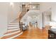 Stunning foyer features a staircase with wooden rails, hardwood floors, and an open layout at 1506 Venetian Way Dr, Waxhaw, NC 28173