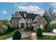 Charming two-story home featuring a blend of stone and stucco exterior, well-manicured landscaping, and a welcoming entrance at 1506 Venetian Way Dr, Waxhaw, NC 28173