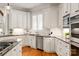 Updated kitchen featuring stainless steel appliances, custom cabinets, and stone countertops at 1506 Venetian Way Dr, Waxhaw, NC 28173