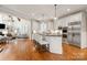 Spacious open kitchen with a large center island, stainless appliances, and hardwood floors at 1506 Venetian Way Dr, Waxhaw, NC 28173