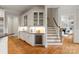 Kitchen with granite counters, wine fridge, custom cabinets, and hardwood floors at 1506 Venetian Way Dr, Waxhaw, NC 28173
