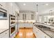 Open concept kitchen with stainless steel appliances, custom cabinets, and granite countertops at 1506 Venetian Way Dr, Waxhaw, NC 28173