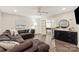 Comfortable living room with dark brown sectional and views of the basement game area at 1506 Venetian Way Dr, Waxhaw, NC 28173