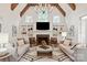 Vaulted living room featuring custom fireplace with built-ins, wood beams, and natural light at 1506 Venetian Way Dr, Waxhaw, NC 28173