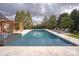 Backyard pool area with lounge chairs and pergola for relaxing and enjoying the outdoors at 1506 Venetian Way Dr, Waxhaw, NC 28173