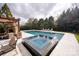 Custom swimming pool with a spa and lounging chairs at 1506 Venetian Way Dr, Waxhaw, NC 28173