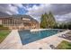 Stunning backyard pool and patio with outdoor seating and lush landscaping, perfect for relaxation and entertaining at 1506 Venetian Way Dr, Waxhaw, NC 28173