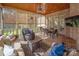 Screened in porch featuring outdoor seating, dining, a ceiling fan, and an outdoor fireplace at 1506 Venetian Way Dr, Waxhaw, NC 28173