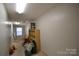 Large unfinished basement space with shelving units and natural light from a window at 1511 Liberty Ave, Albemarle, NC 28001