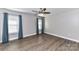 Empty bedroom with wood floors, ceiling fan, and plenty of natural light at 1511 Liberty Ave, Albemarle, NC 28001