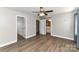 Bedroom featuring a ceiling fan, wood floors, closet, and bathroom at 1511 Liberty Ave, Albemarle, NC 28001
