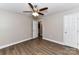 Bedroom with wood-look floors, ceiling fan, and ensuite bathroom access at 1511 Liberty Ave, Albemarle, NC 28001