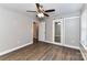 Bedroom with wood-look floors, ceiling fan, and sliding closet doors at 1511 Liberty Ave, Albemarle, NC 28001
