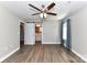 Bedroom featuring a ceiling fan, wood floors, bathroom, and closet at 1511 Liberty Ave, Albemarle, NC 28001