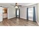 Bright bedroom with wood-look floors, ceiling fan, and ensuite bathroom access at 1511 Liberty Ave, Albemarle, NC 28001