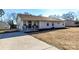 Ranch-style home with fresh landscaping and a paved driveway leading to a cozy front porch at 1511 Liberty Ave, Albemarle, NC 28001