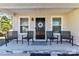 Welcoming front porch adorned with seating, a charming wreath, and a stylish entrance at 1511 Liberty Ave, Albemarle, NC 28001