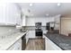 Bright kitchen features granite counters, stainless steel appliances, and wood floors at 1511 Liberty Ave, Albemarle, NC 28001