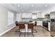 Modern kitchen with white cabinets, stainless steel appliances, and stylish bar stool seating at 1511 Liberty Ave, Albemarle, NC 28001