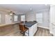 Open-concept kitchen features wood floors, a center island with seating, and lots of natural light at 1511 Liberty Ave, Albemarle, NC 28001