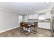 Open-concept kitchen features wood floors, a center island with seating, stainless steel appliances, and granite counters at 1511 Liberty Ave, Albemarle, NC 28001
