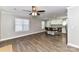 Spacious living area featuring hardwood floors, a ceiling fan, and an adjacent kitchen area at 1511 Liberty Ave, Albemarle, NC 28001