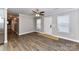 Cozy living area with hardwood floors and access to a hallway and a bright window at 1511 Liberty Ave, Albemarle, NC 28001