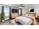 Comfortable main bedroom with ceiling fan, wood floors, dresser, and windows with blinds at 1511 Liberty Ave, Albemarle, NC 28001