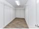 Spacious walk-in closet with custom shelving and wood-look floors at 1511 Liberty Ave, Albemarle, NC 28001