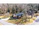 A beautiful aerial view of a home with lush landscaping and a metal roof on a sunny day at 1552 10Th Street Nw Pl, Hickory, NC 28601