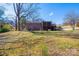 A two-story brick home with a large screened porch and deck, complemented by a spacious backyard at 1552 10Th Street Nw Pl, Hickory, NC 28601