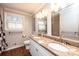 Bathroom featuring double sinks, granite countertop, and decorative mirrors at 1552 10Th Street Nw Pl, Hickory, NC 28601
