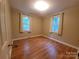 Sunlit bedroom featuring hardwood floors, neutral walls, and large windows creating a bright and airy feel at 1552 10Th Street Nw Pl, Hickory, NC 28601
