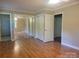Bright bedroom features hardwood floors, closet with mirror doors, and neutral walls providing a cozy atmosphere at 1552 10Th Street Nw Pl, Hickory, NC 28601