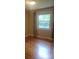 Cozy bedroom has hardwood floors, a window with curtains and neutral walls creating a relaxing atmosphere at 1552 10Th Street Nw Pl, Hickory, NC 28601