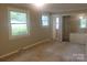 Bright bedroom featuring carpet, two windows that provide an outdoor view, and closet with sliding mirror doors at 1552 10Th Street Nw Pl, Hickory, NC 28601